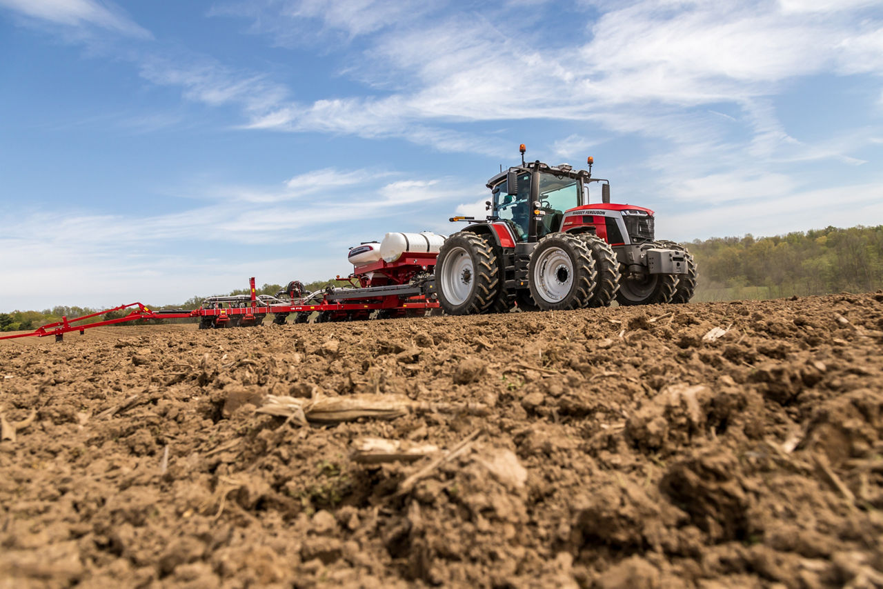 A tractor using PTx Trimble technology to plant a field
