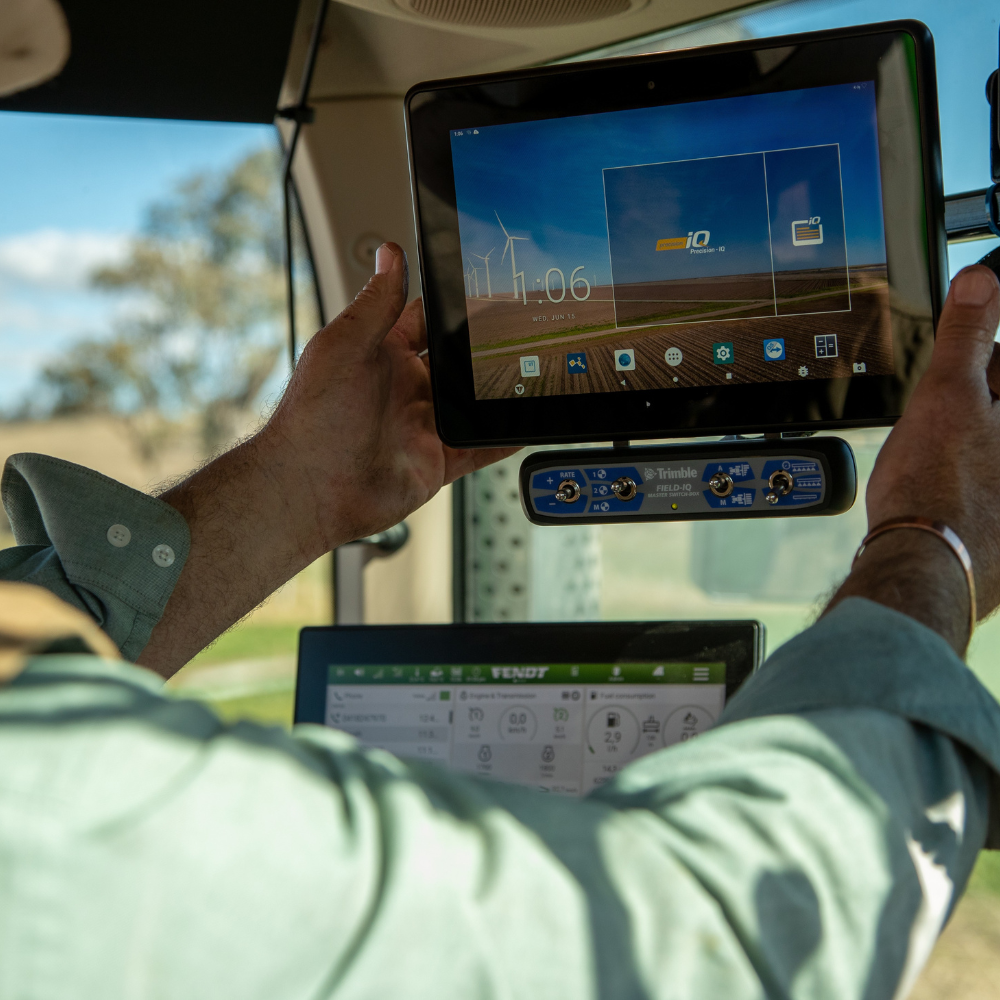 A farmer adjusts his PTx Trimble GFX display