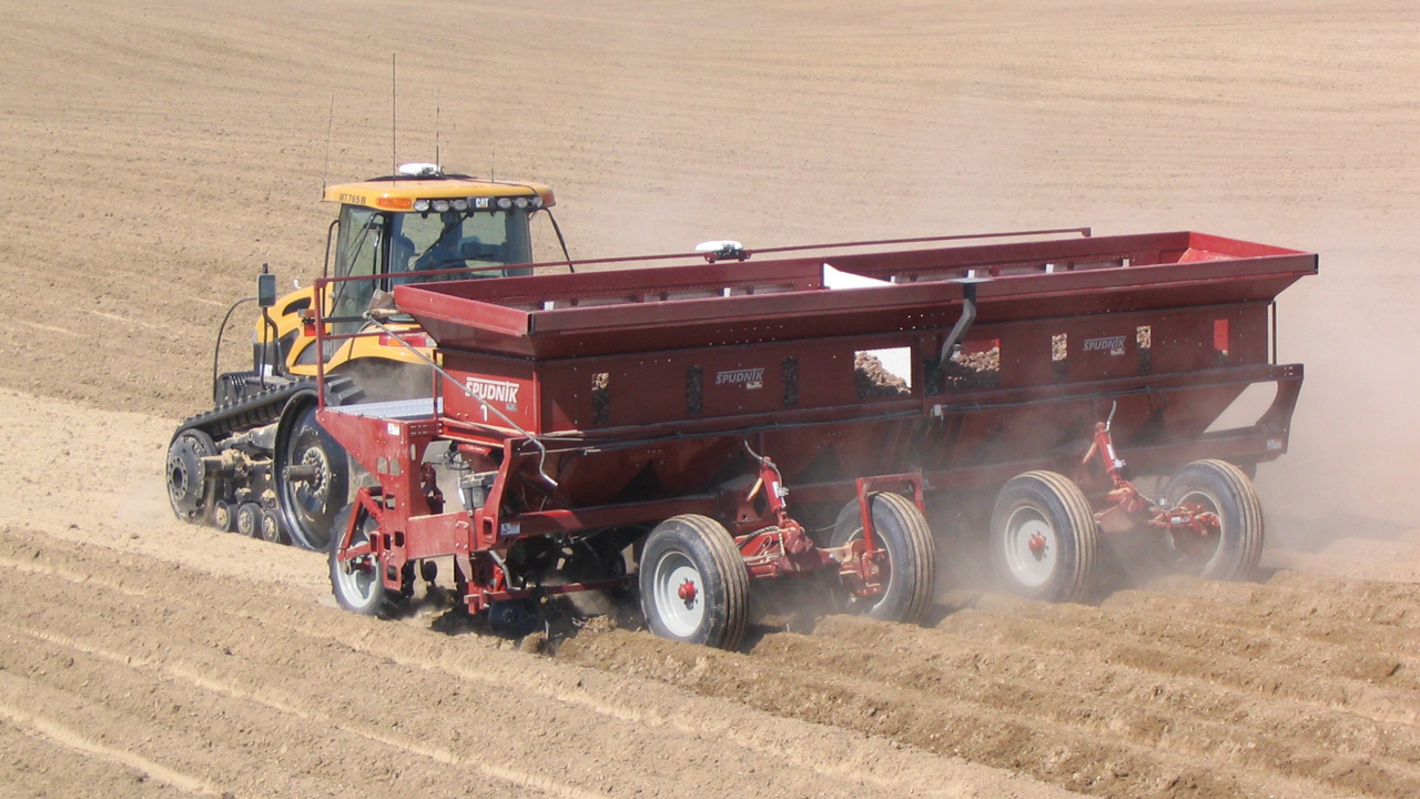 A farmer plants potatoes using the PTx Trimble Autopilot steering system.