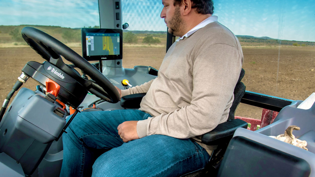 PTx Trimble EZ-Pilot Pro motor drive steering system in a tractor cab