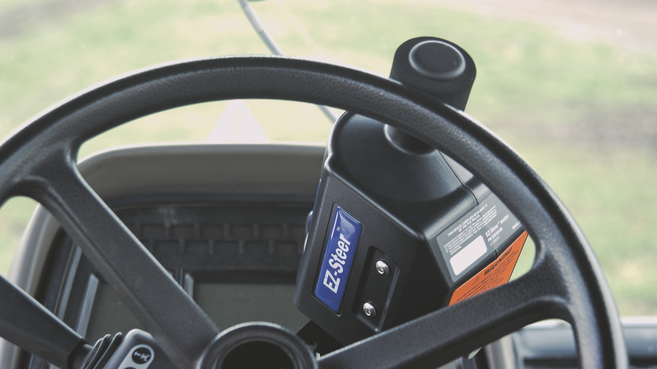 The PTx Trimble EZ-Steer steering system in the cab of a tractor.
