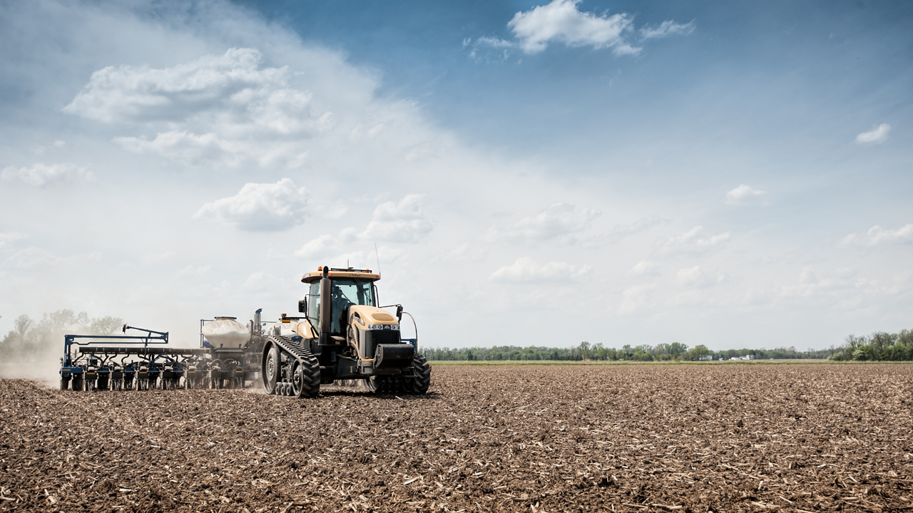 A tractor plants using PTx Trimble technology.