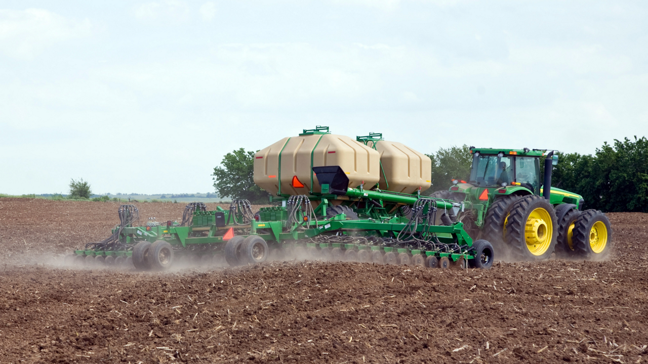 A tractor planting a field.