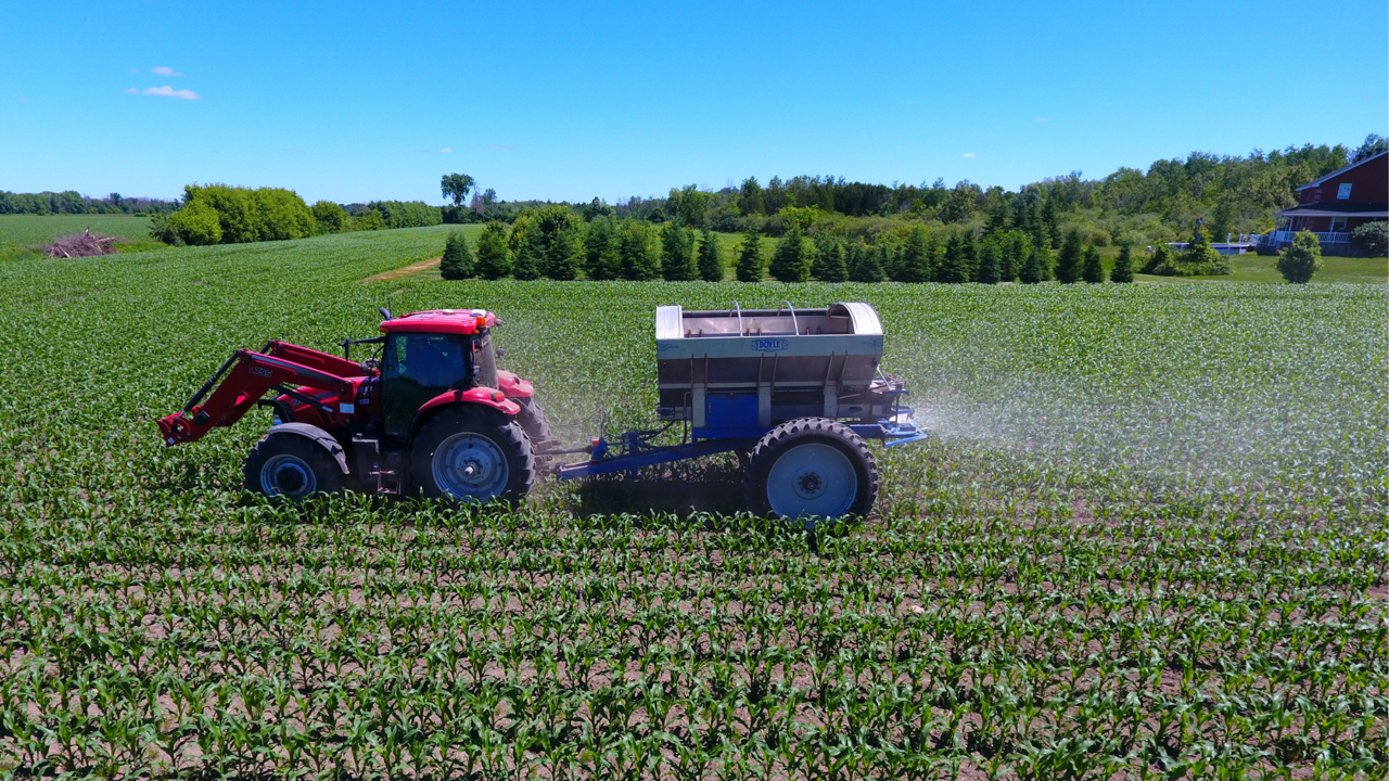 A tractor and spreader in the field.