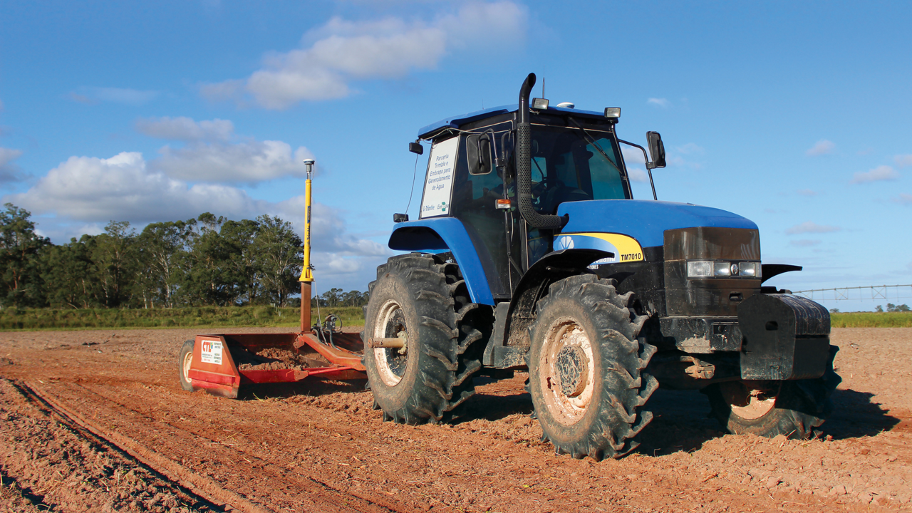 A tractor in the field using PTx Trimble's FieldLevel II system.