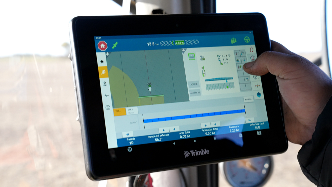 Farmer with hand on a PTx Trimble GFX display.