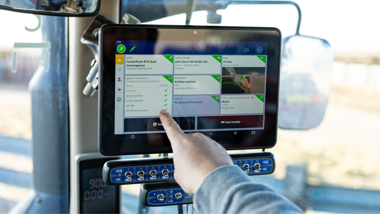 Farmer in field with PTx Trimble GFX precision agriculture display — ChDp Ventures support