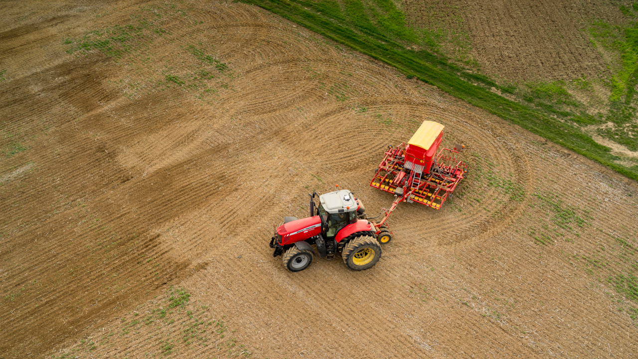 Farmer turning at end of field while planting