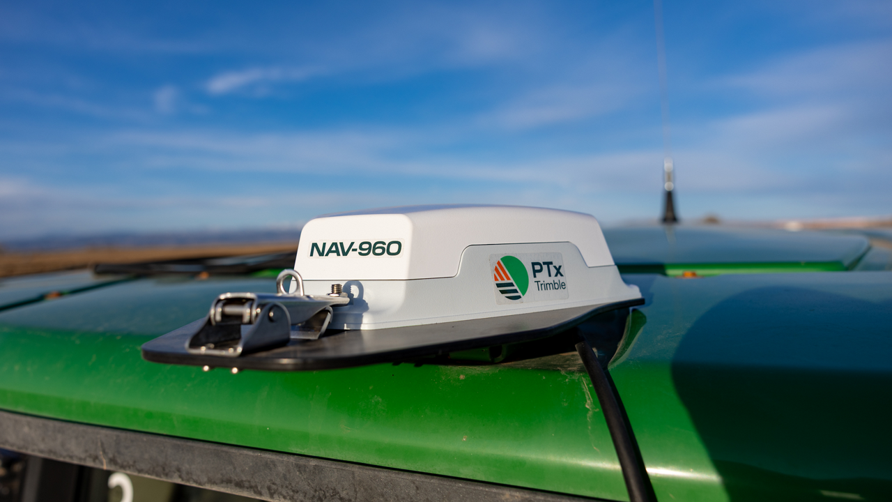 The NAV-960 receiver on the roof of a tractor from the back.