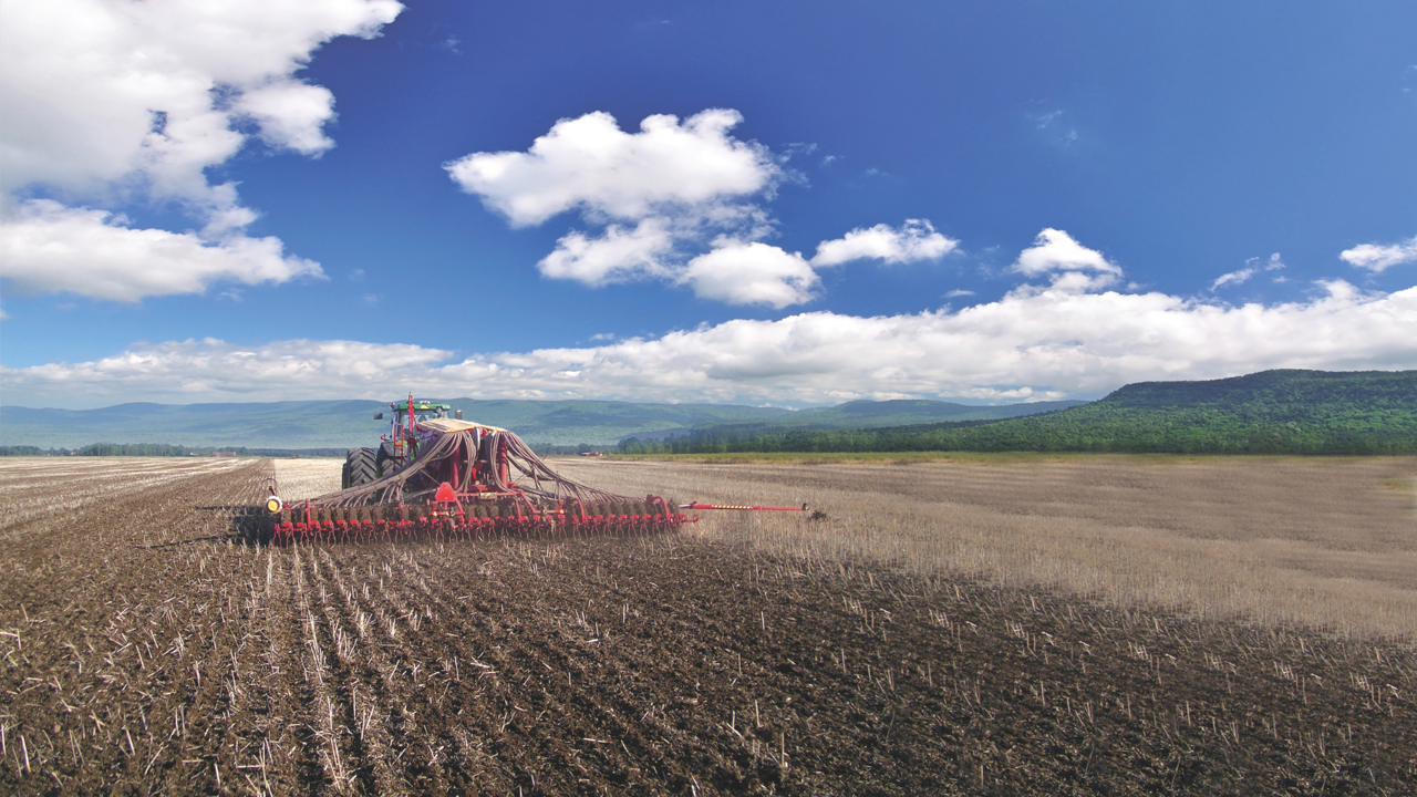 A tractor seeds a field.