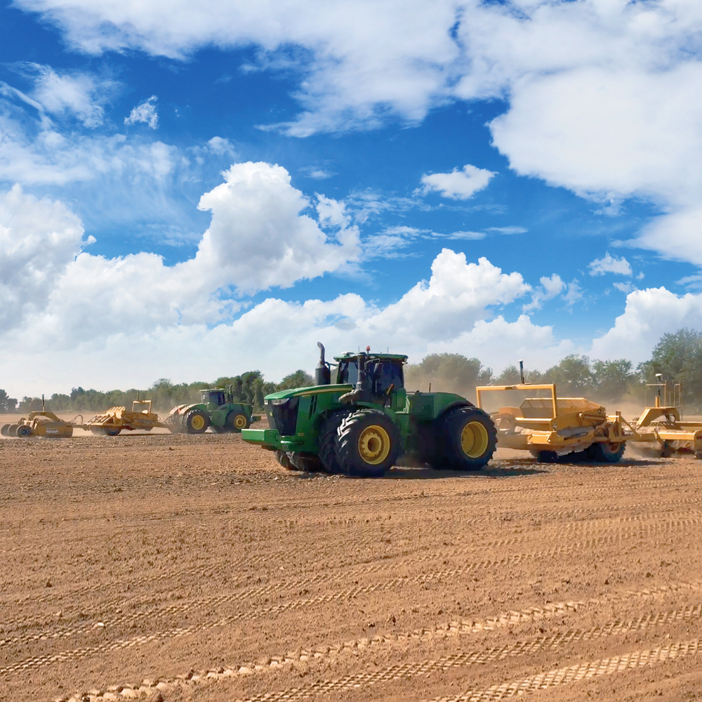 Several tractors move dirt using PTx Trimble's VerticalPoint RTK grade control system.