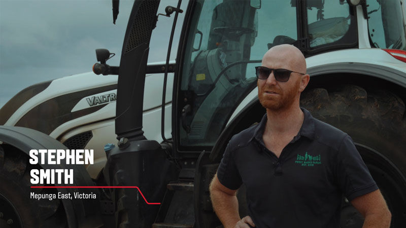 A Valtra customer from Victoria, Australia stands in front of his Valtra tractor