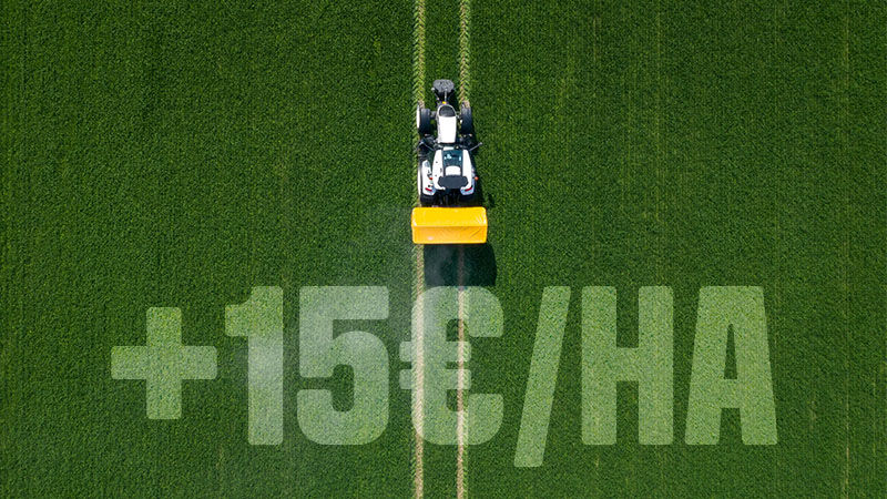 A Valtra tractor fitted with Valtra Unlimited Smart Top Link spreading fertiliser with a rear-mounted fertiliser spreader