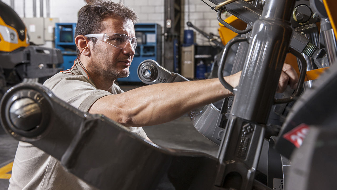 Man working on Valtra tractor engine