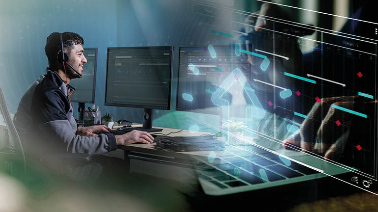 A technician looking at various screens with icons superimposed