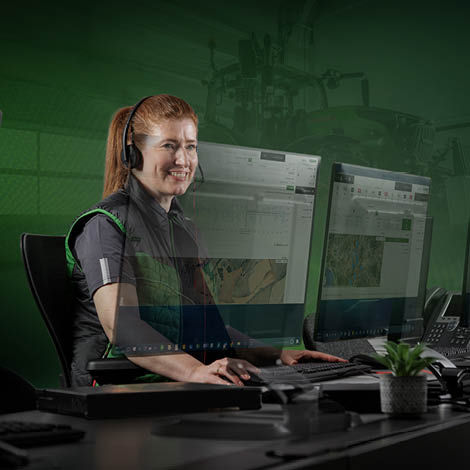 A woman in a Fendt jacket looking at screens