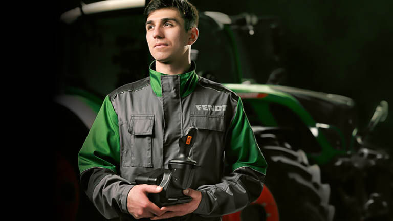 A Fendt technican holding a joystick