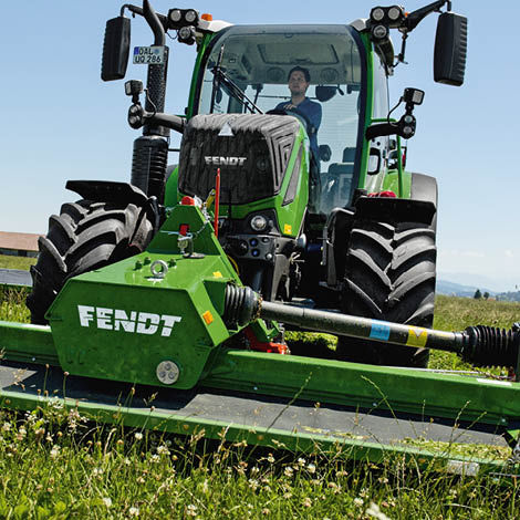 A Fendt tractor with a cutter accessory on the front