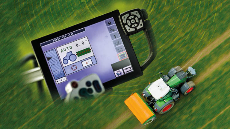 A Fendt tractor in a field with a superimposed image of a screen with spray data