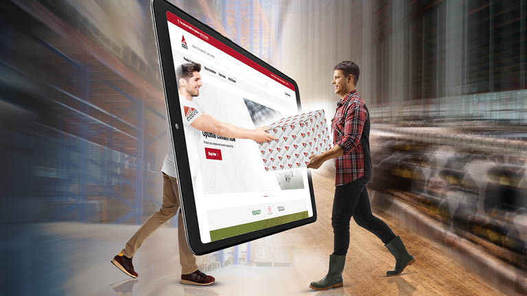 A man handing another man an AGCO parts box through a computer screen