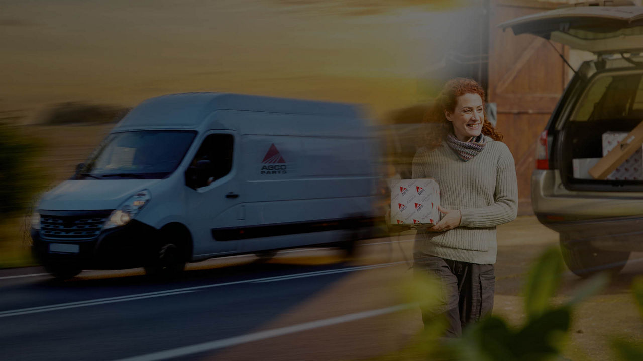 A van is driving down a road on the left, fading into an image of a woman holding a parts box on the right
