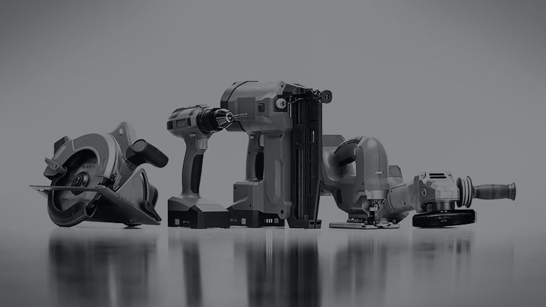 A picture of various power tools on a grey background