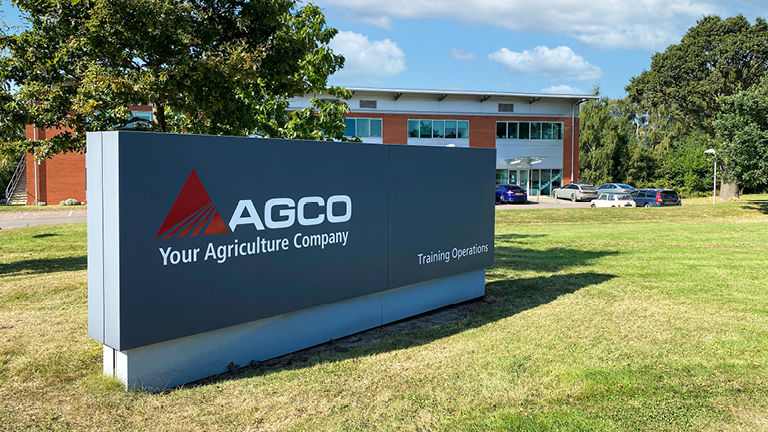 A sign for the AGCO Traning Centre Stoneleigh with the building in the background