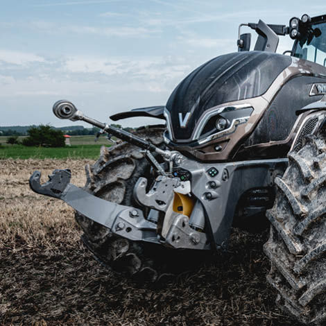 A picture of the front of a tractor with the front linkage prominently shown