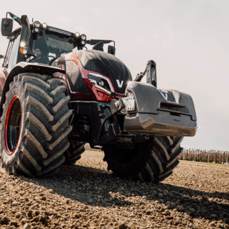 A picture of a Valtra tractor with a front weight attached