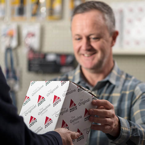 Farmer receiving AGCO Parts box from dealer 