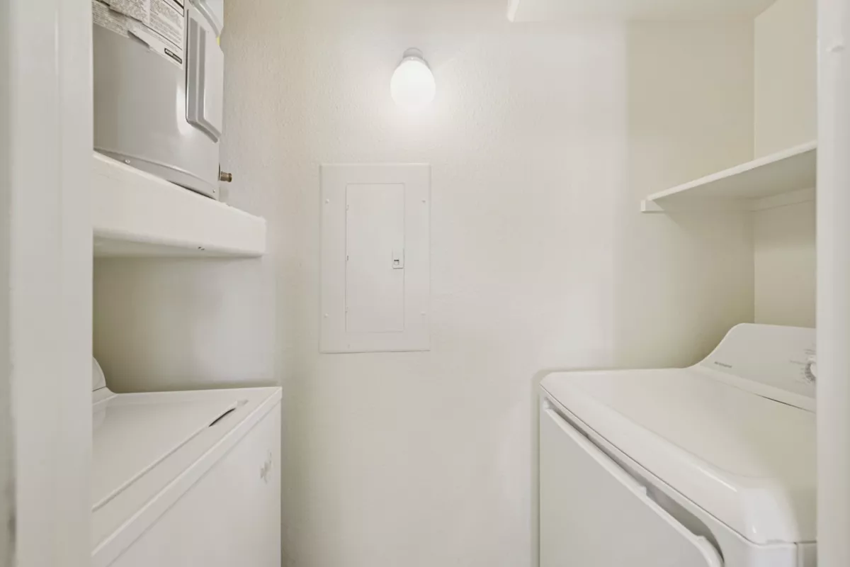 Laundry room with washer, dryer and shelving at Indigo Creek