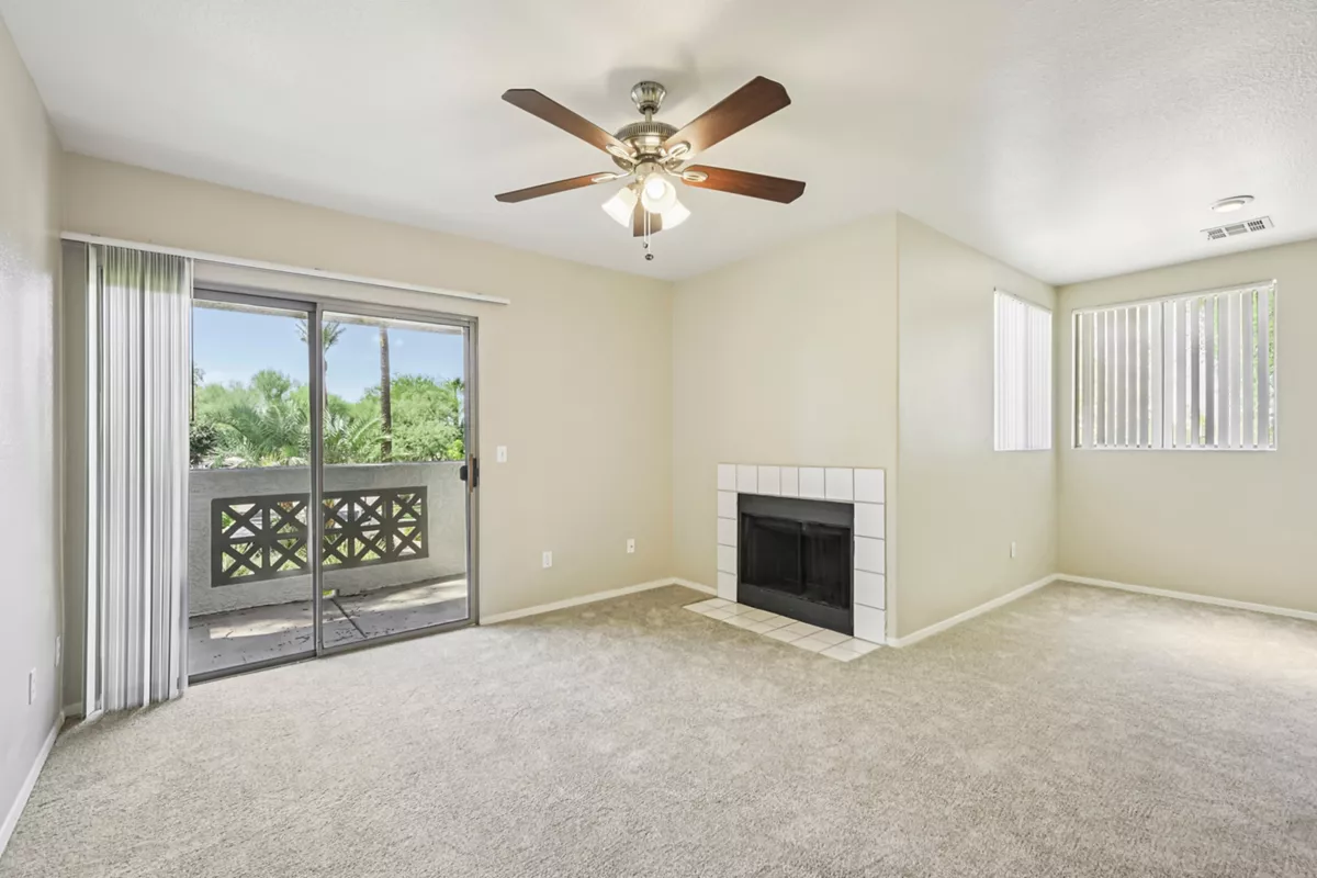 Living room with fireplace and balcony access at Indigo Creek