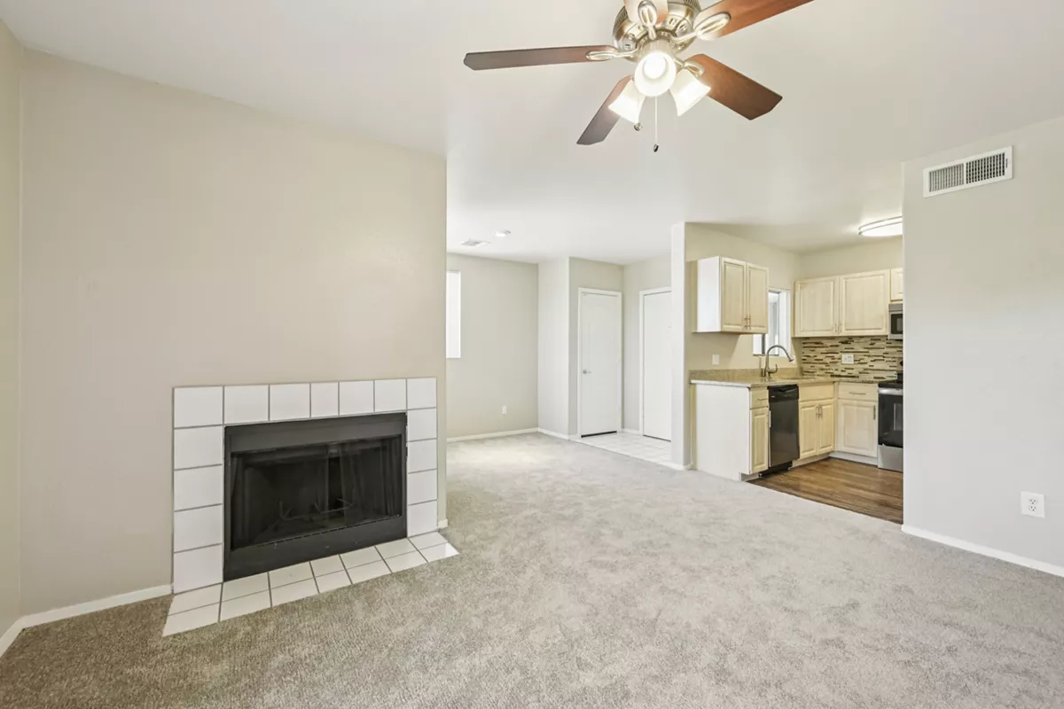 Unfurnished living room with fireplace beside the kitchen at Indigo Creek