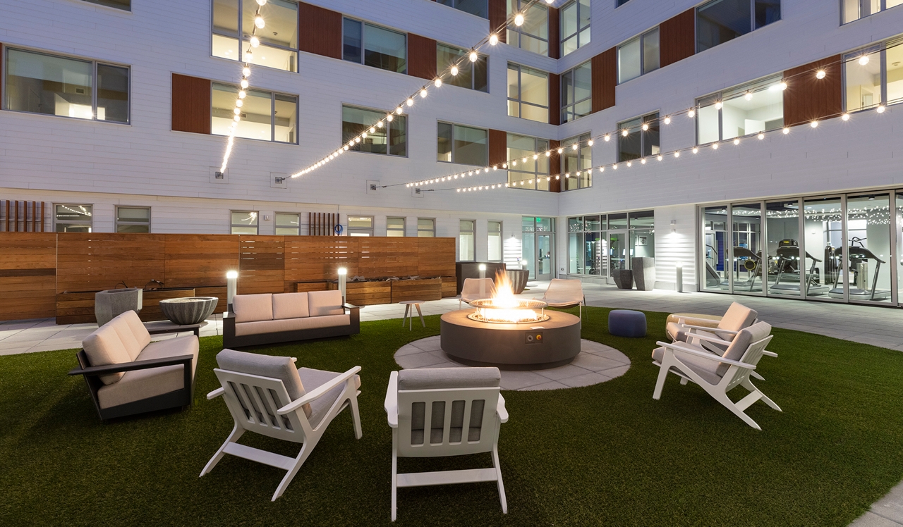 Prism Apartments | Cambridge, MA | Outdoor fire place at night.