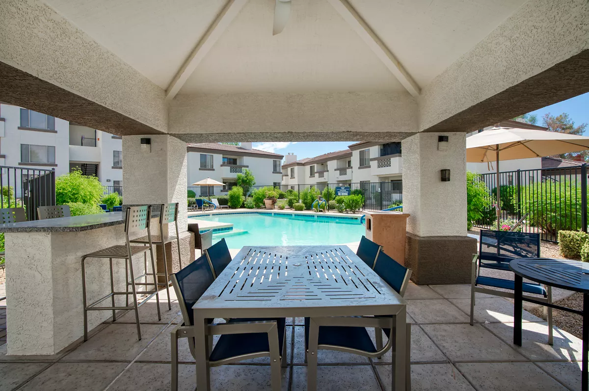 Covered poolside dining and grilling area at Indigo Creek
