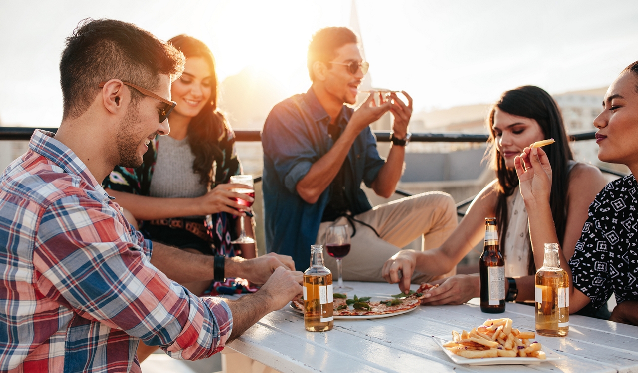 One Greenway - Boston, MA - Friends eating and drinking on a rooftop