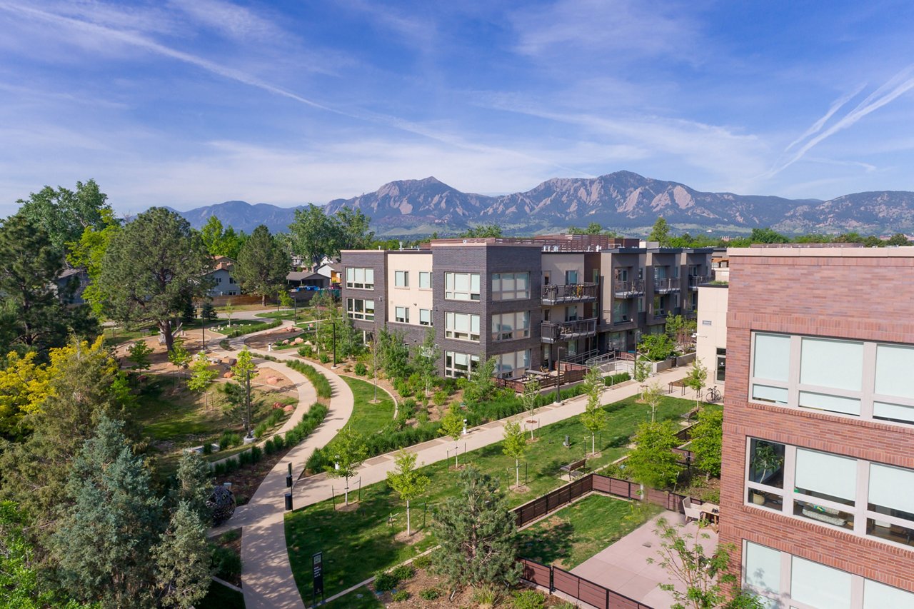 Parc Mosaic Apartment homes exterior with view of the boulder flarion mountains and city scape