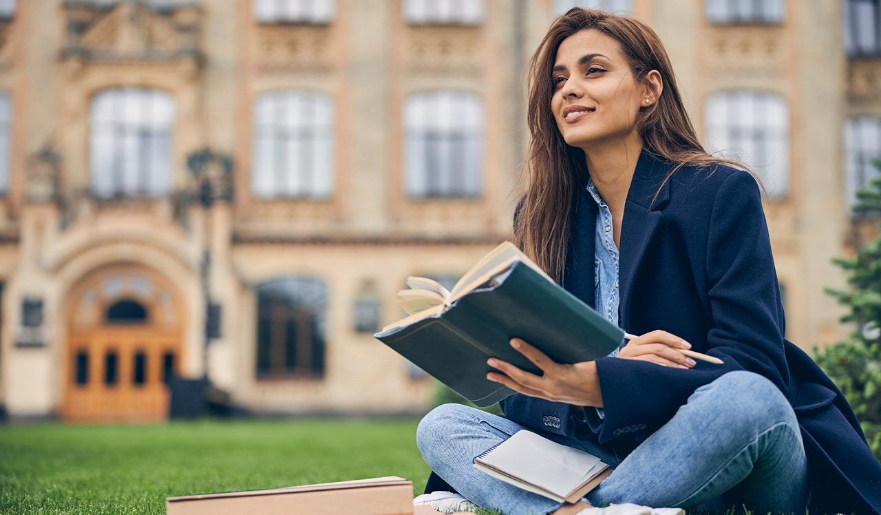 Student with a book on campus