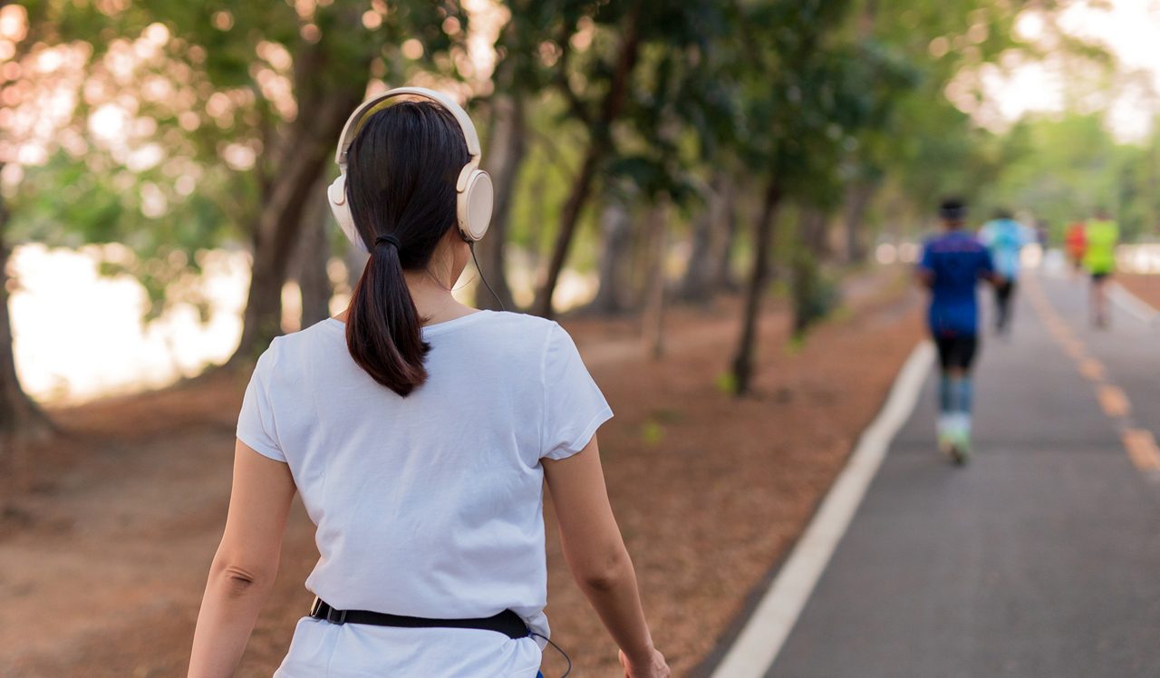 Woman exercising in the park with headphones on