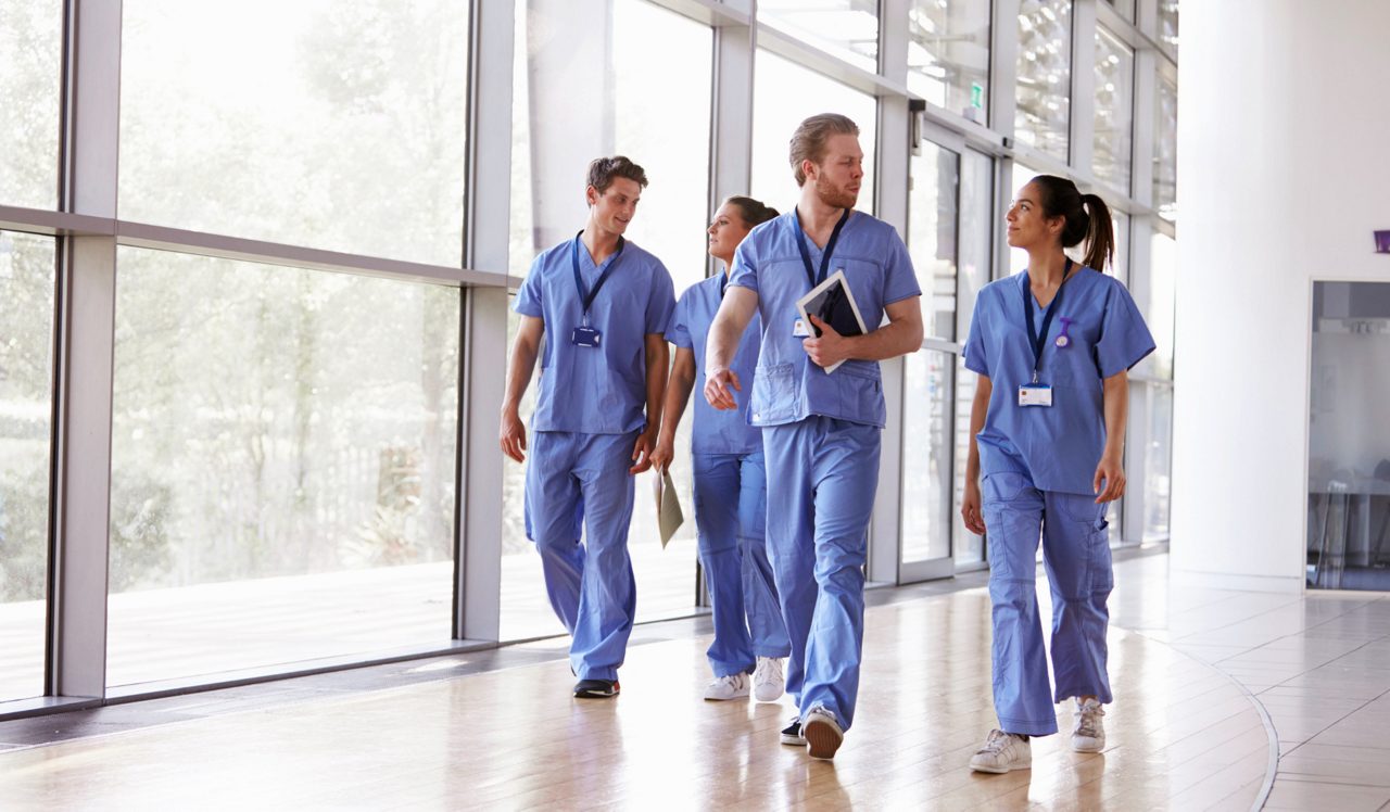 People in scrubs walking