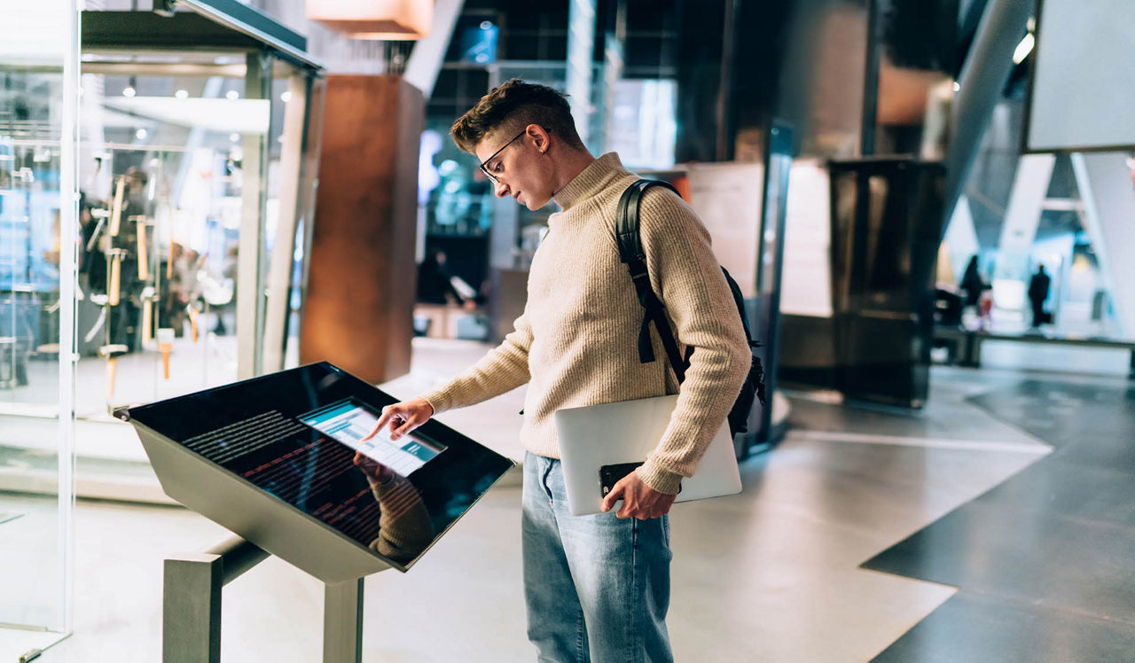 Monterey Grove - San Jose, CA - Guy looking at interactive kiosk