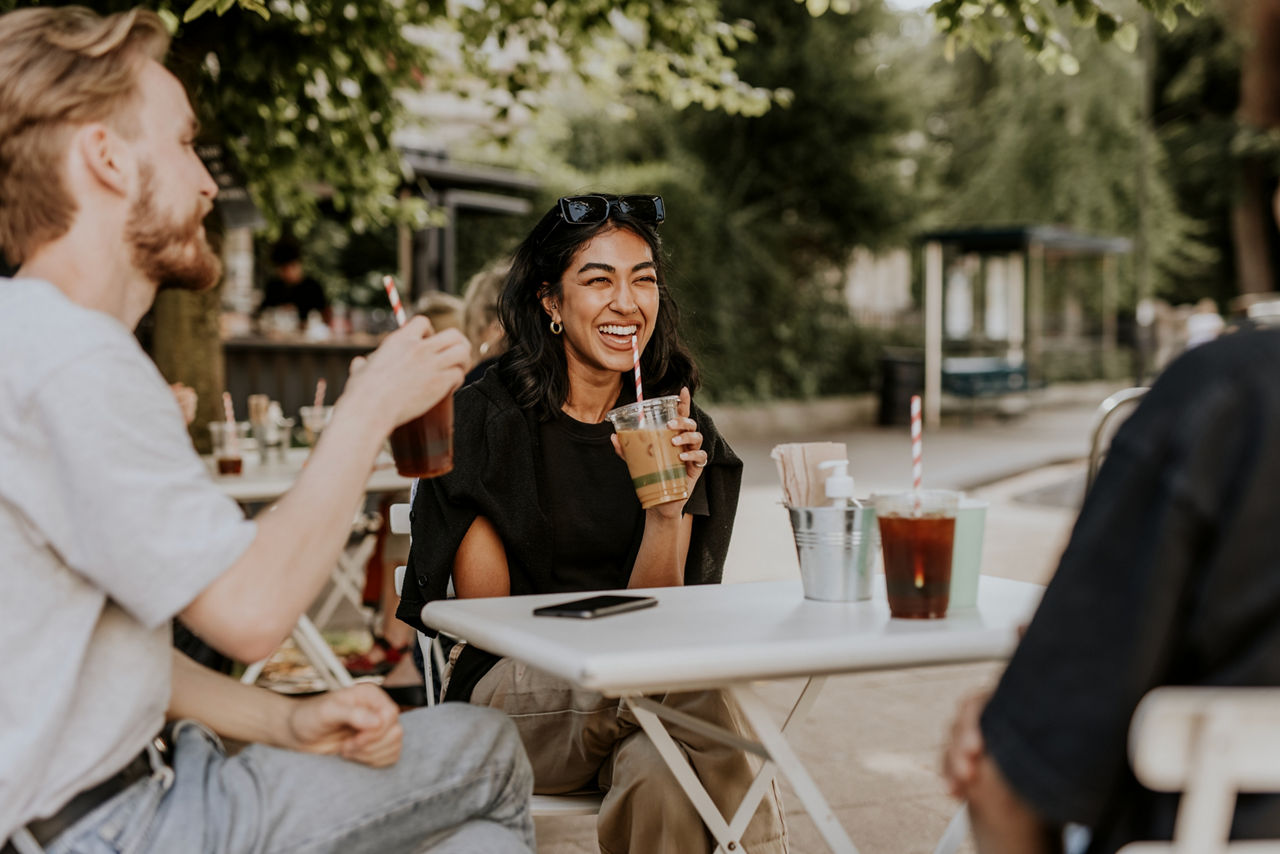 friends enjoying coffee at a table outside