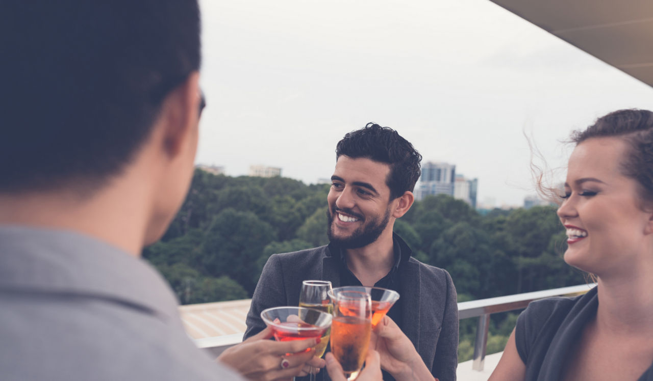 Park Towne Place | Philadelphia, PA | 3 friends clinking cocktail classes on a rooftop