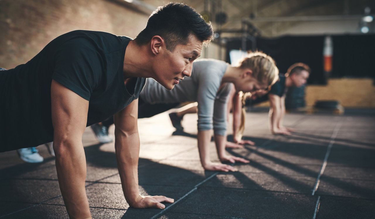 Vivo Apartment Homes | Cambridge, MA | People doing pushups .<div style="text-align: center;">&nbsp;</div>
<div style="text-align: center;">Orangetheory Fitness is located right downstairs.</div>
