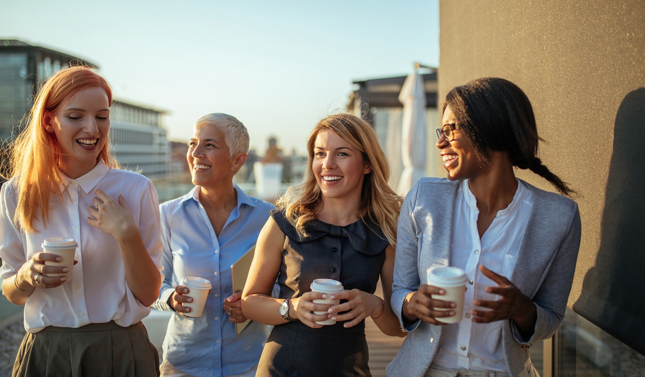 The Sterling Apartment Homes - Philadelphia, PA - Friends talking on a rooftop patio