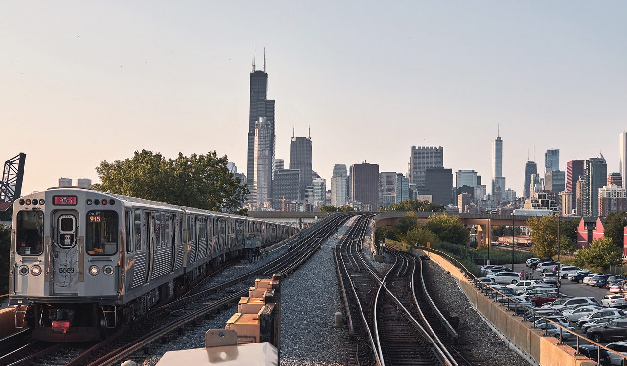 Chicago skyline, cityscape. Train in motion on railway. Taken from chinatown downtown