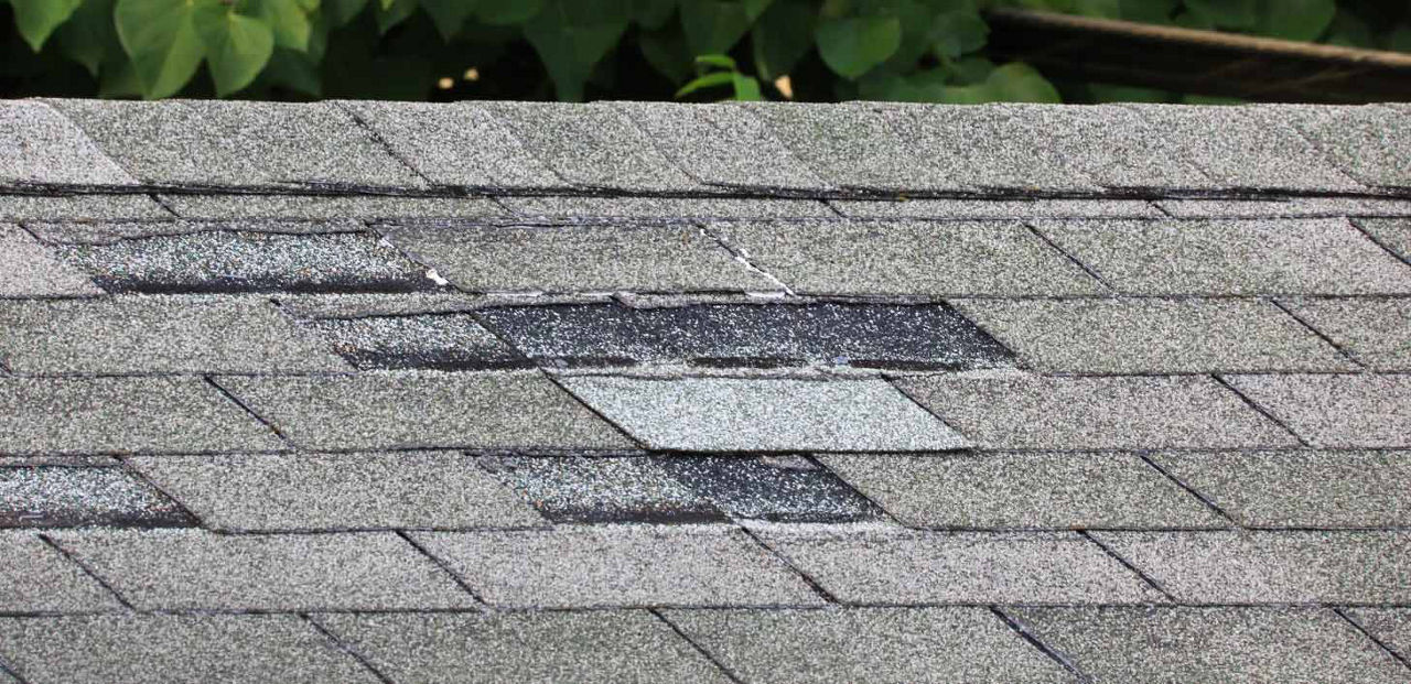 An old roof with worn out shingles.