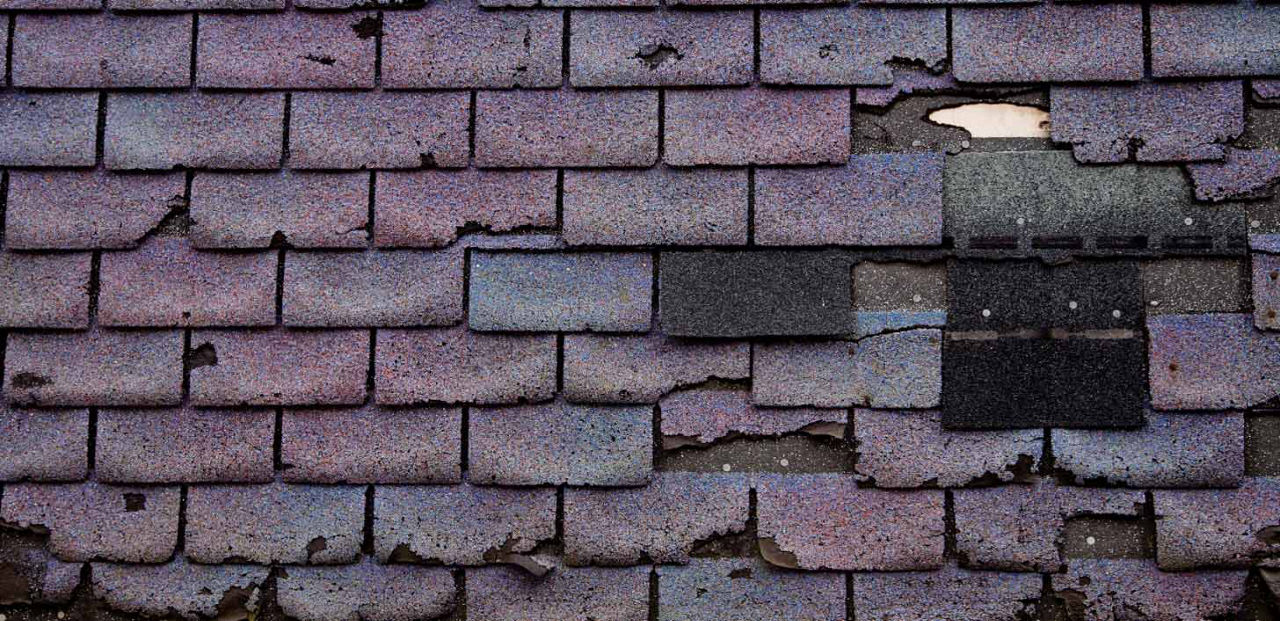 An old roof with cracked shingles. 