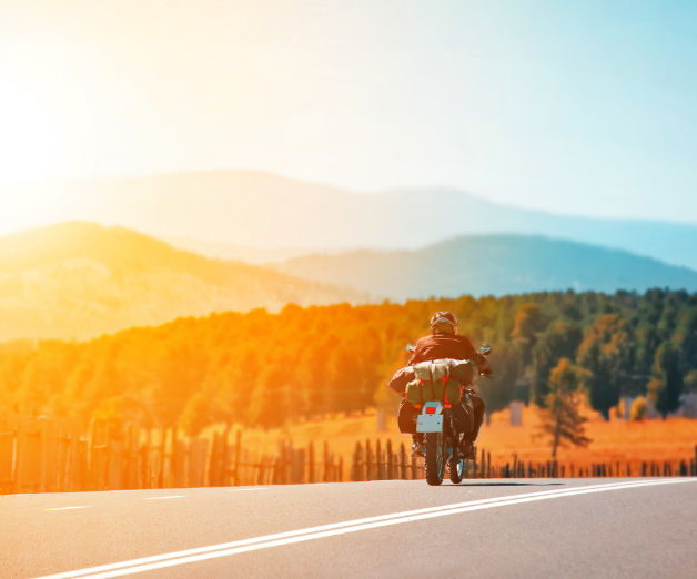 Motorcyclist traveling down a mountain highway