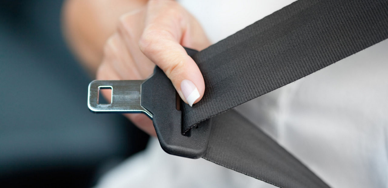 Person buckling seatbelt.